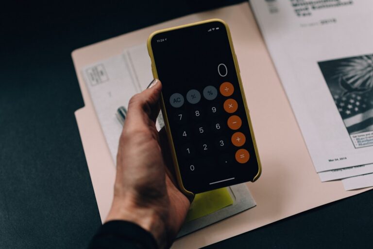 Calculator and documents on a desk representing mortgage planning